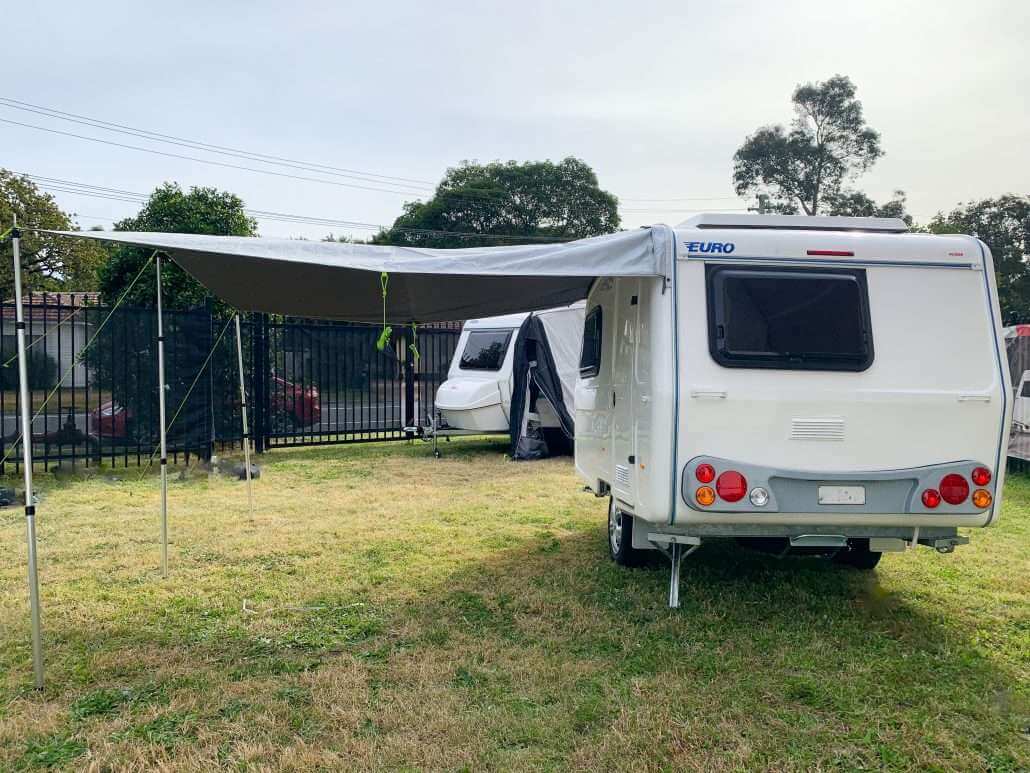 Back view of awning displayed on a caravan on grass